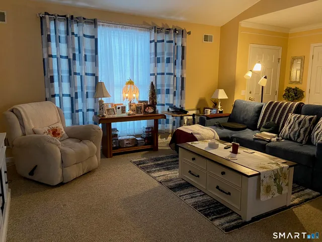 a view of a chair and tables in the patio