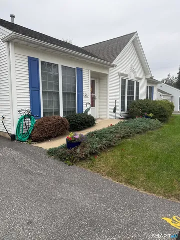 a front view of a house with garden and porch