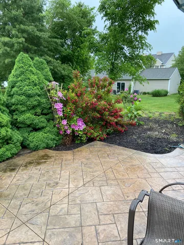 a kitchen with stainless steel appliances granite countertop a sink a stove a refrigerator cabinets and dining table