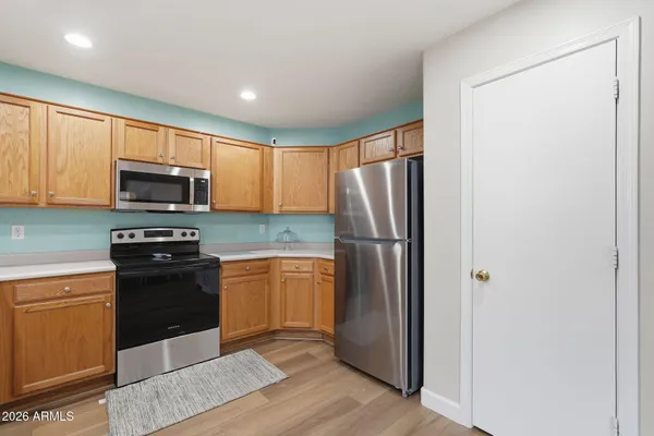 a kitchen with stainless steel appliances granite countertop a refrigerator stove and microwave