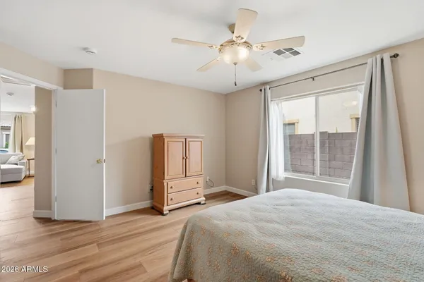 a bedroom with a large bed and a large window