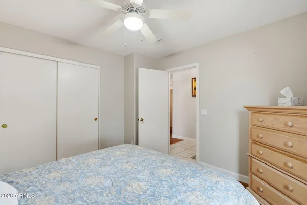 a bedroom with a bed and a dresser in it