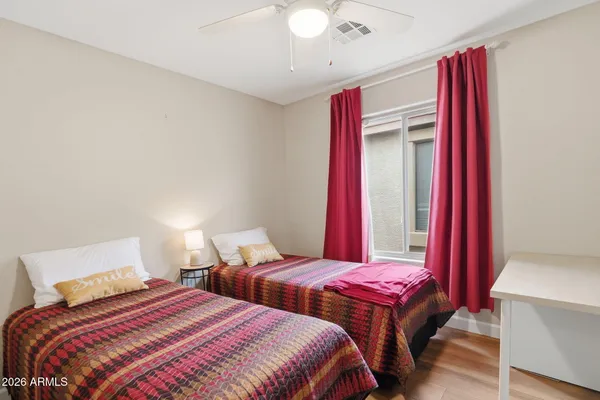 a bedroom with two beds and a chandelier