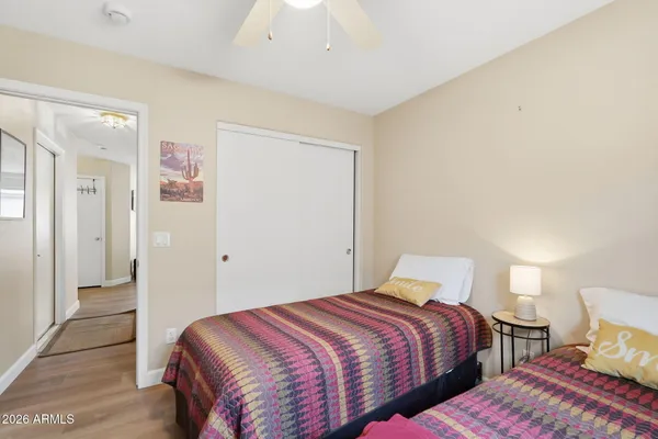 a bedroom with two beds and a dresser