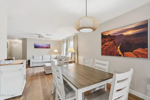 a view of a dining room with furniture wooden floor and chandelier