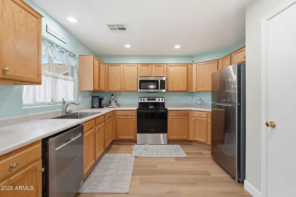 a kitchen with a refrigerator a sink and a stove