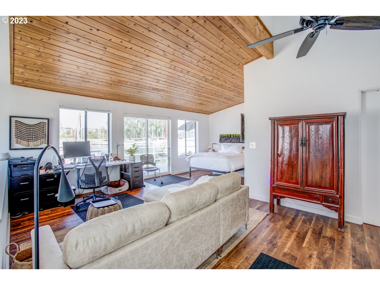 173 Northeast Bridgeton Road, Unit 24 Portland, OR 97211 - Photo 29 of 36 a living room with furniture a wooden floor and a large window