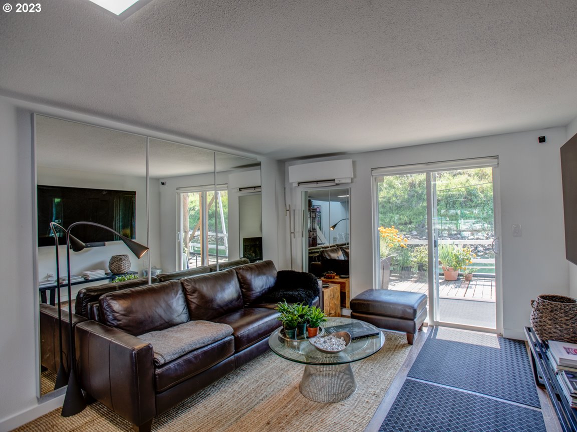 173 Northeast Bridgeton Road, Unit 24 Portland, OR 97211 - Photo 5 of 36 a living room with furniture and a large window
