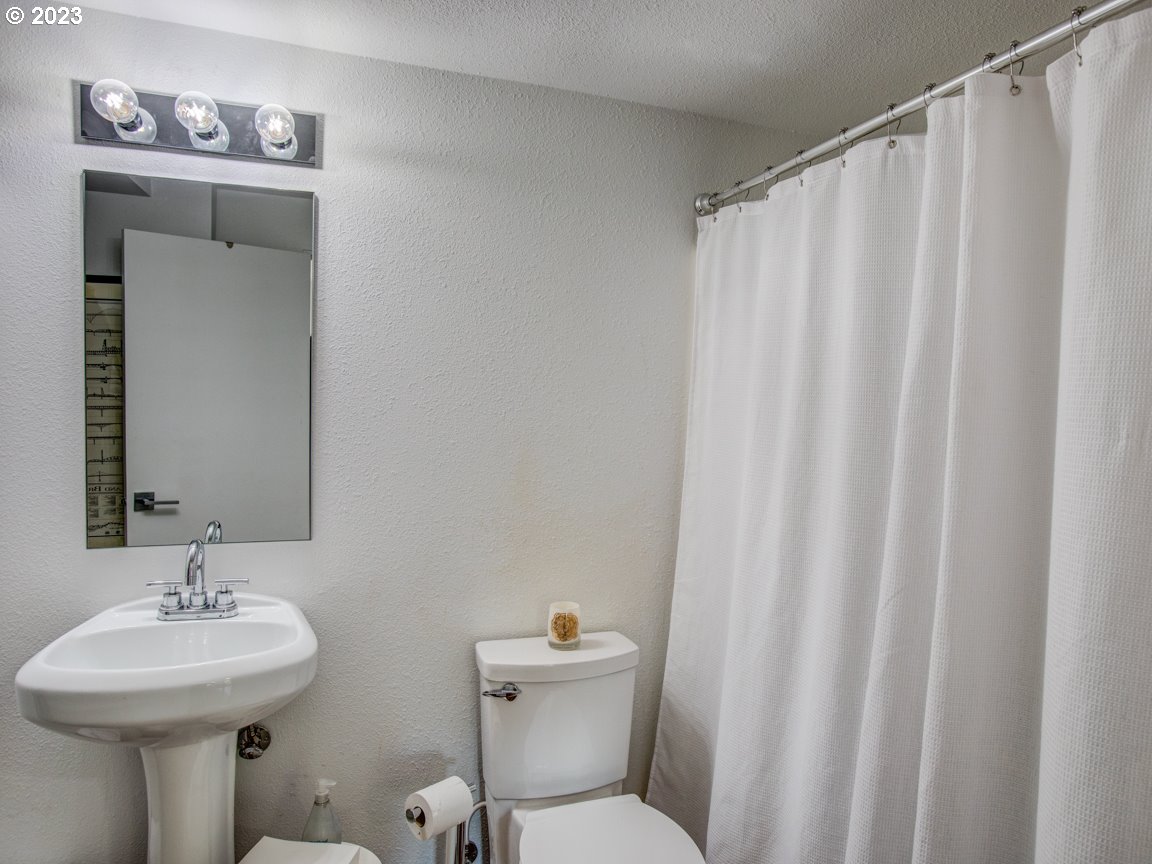 173 Northeast Bridgeton Road, Unit 24 Portland, OR 97211 - Photo 8 of 36 a bathroom with a sink mirror and toilet