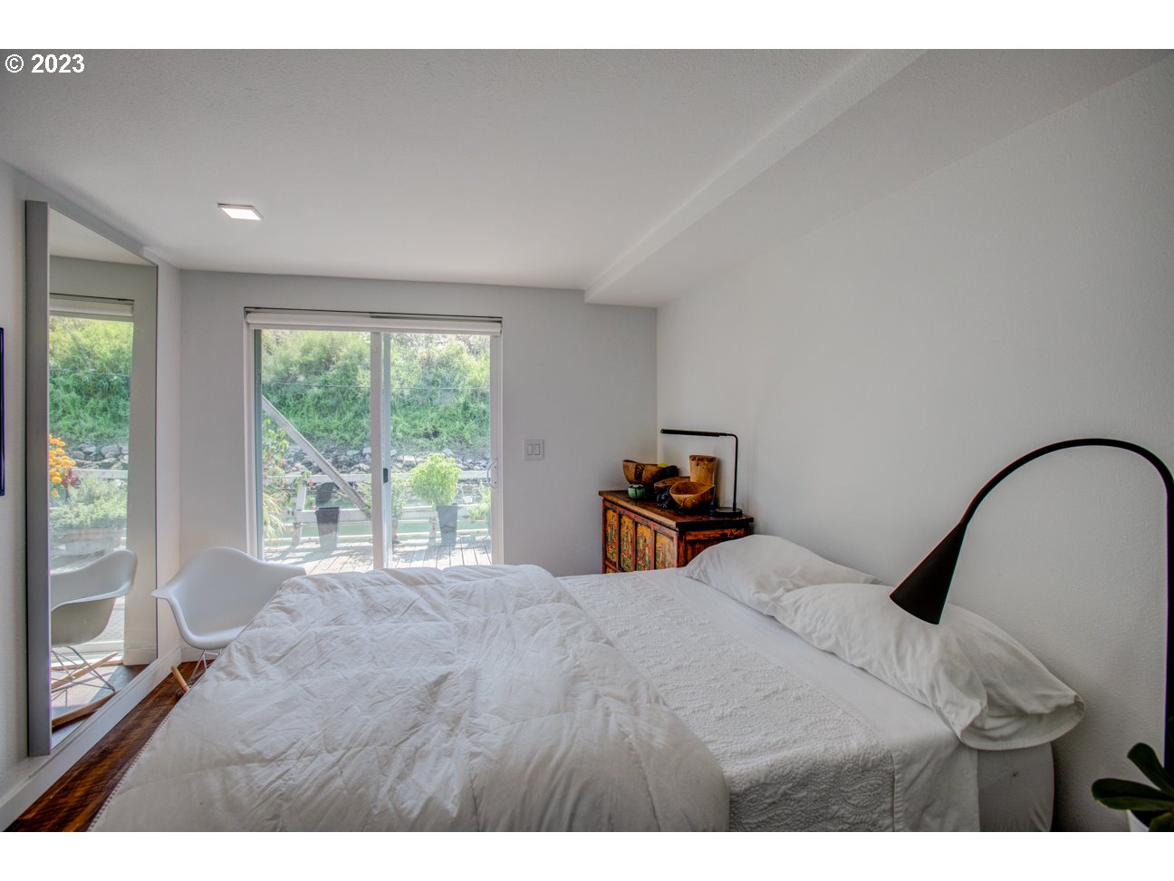 173 Northeast Bridgeton Road, Unit 24 Portland, OR 97211 - Photo 9 of 36 a bedroom with a bed and a large window