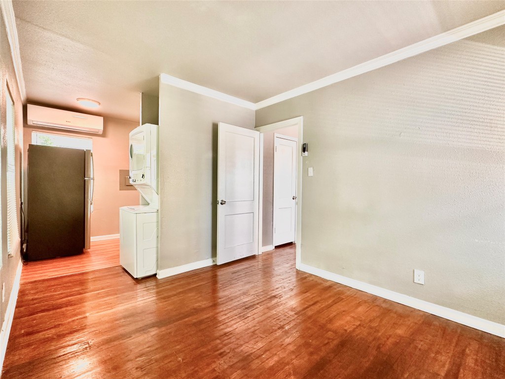 204 East 30th Street, Unit 103 Austin, TX 78705 - Photo 3 of 7 a view of an empty room with wooden floor and a bathroom