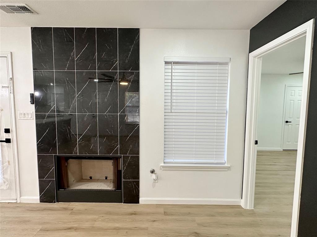 601 Short Street McKinney, TX 75069 - Photo 12 of 28 a view of a room with wooden floor and windows