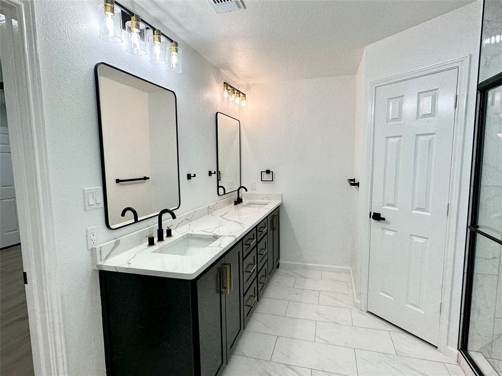 601 Short Street McKinney, TX 75069 - Photo 16 of 28 a bathroom with a double vanity sink and mirror