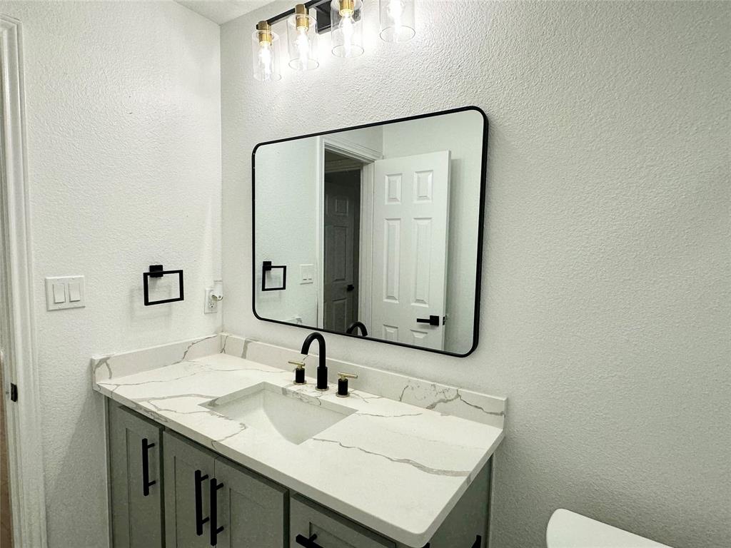 601 Short Street McKinney, TX 75069 - Photo 18 of 28 a bathroom with a sink and a mirror