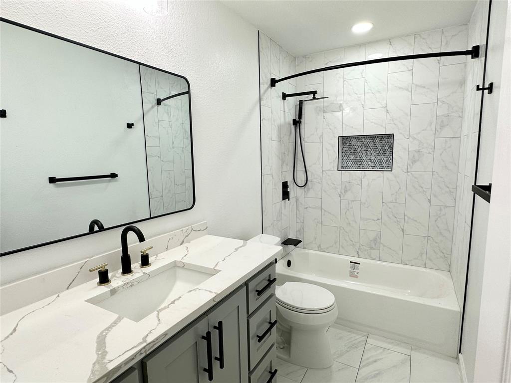 601 Short Street McKinney, TX 75069 - Photo 20 of 28 a bathroom with a granite countertop sink a toilet and shower