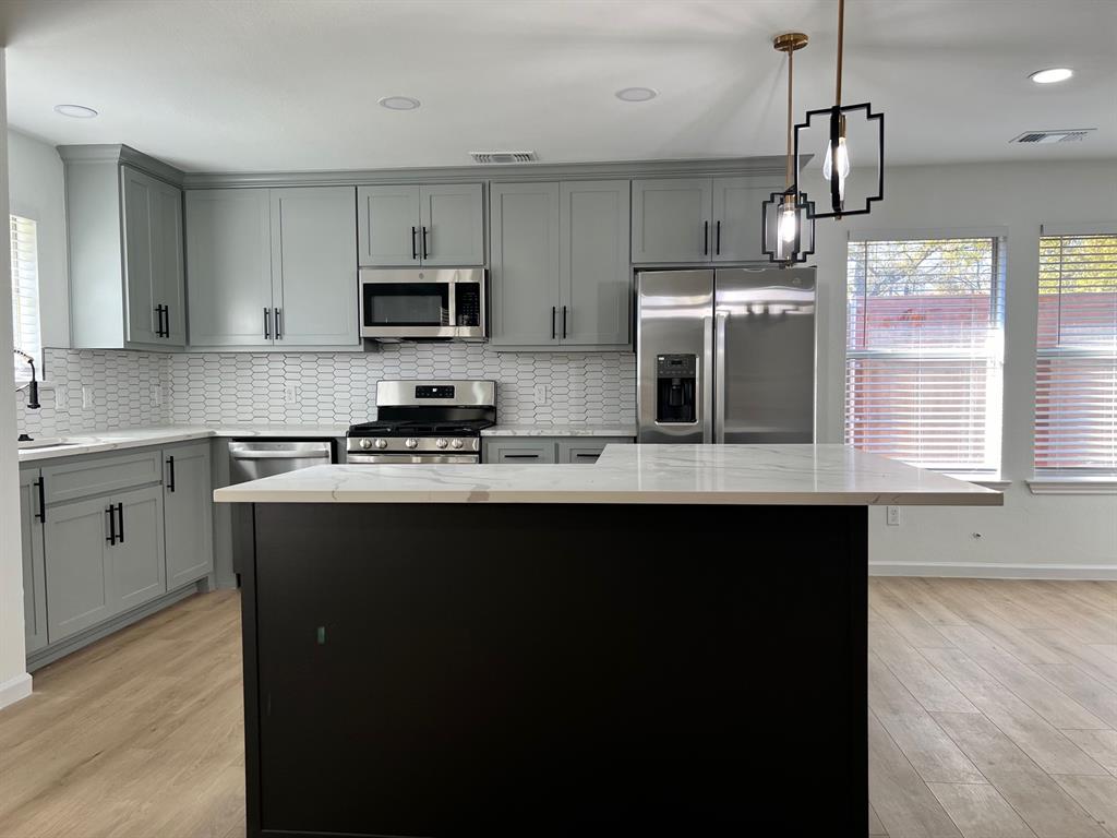 601 Short Street McKinney, TX 75069 - Photo 24 of 28 a kitchen with stainless steel appliances granite countertop a sink a stove a refrigerator and cabinets