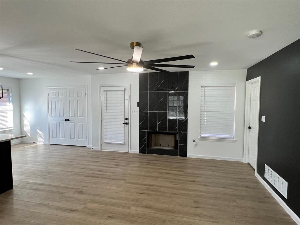 601 Short Street McKinney, TX 75069 - Photo 27 of 28 a view of empty room with wooden floor and refrigerator