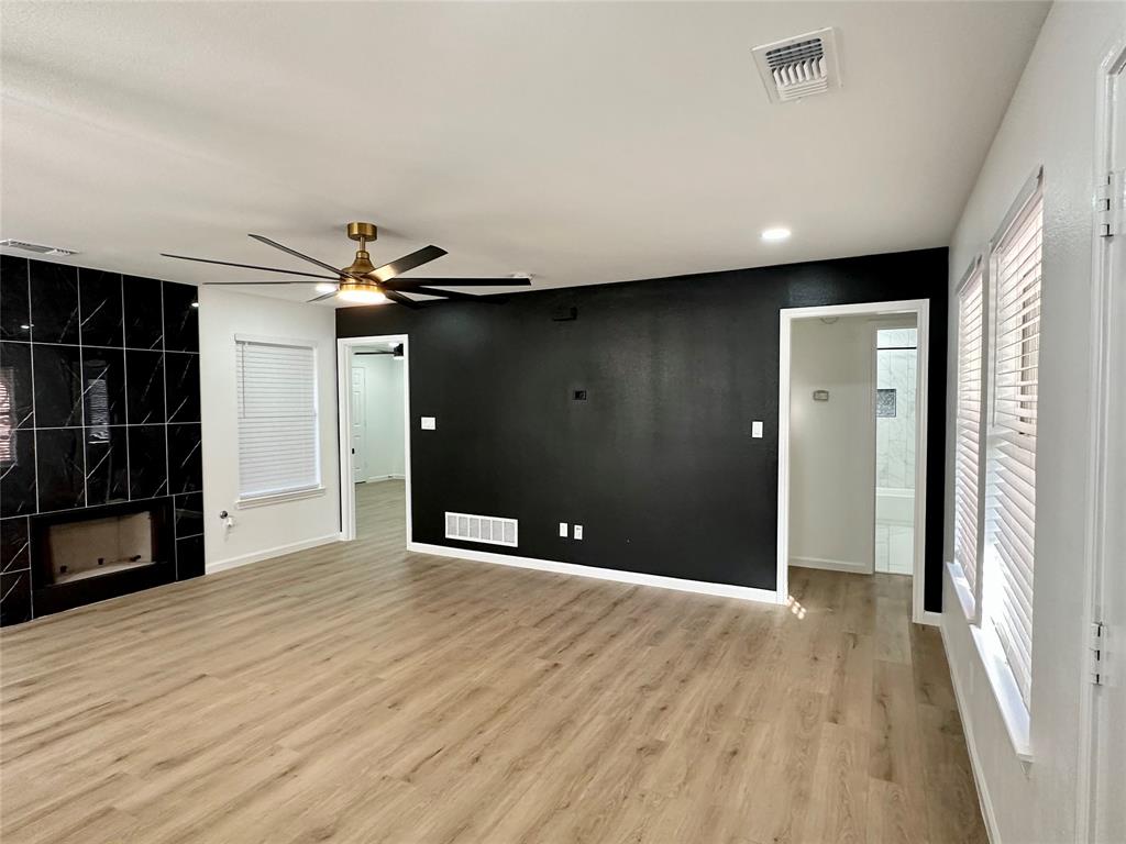 601 Short Street McKinney, TX 75069 - Photo 10 of 28 a view of an empty room with wooden floor and a window
