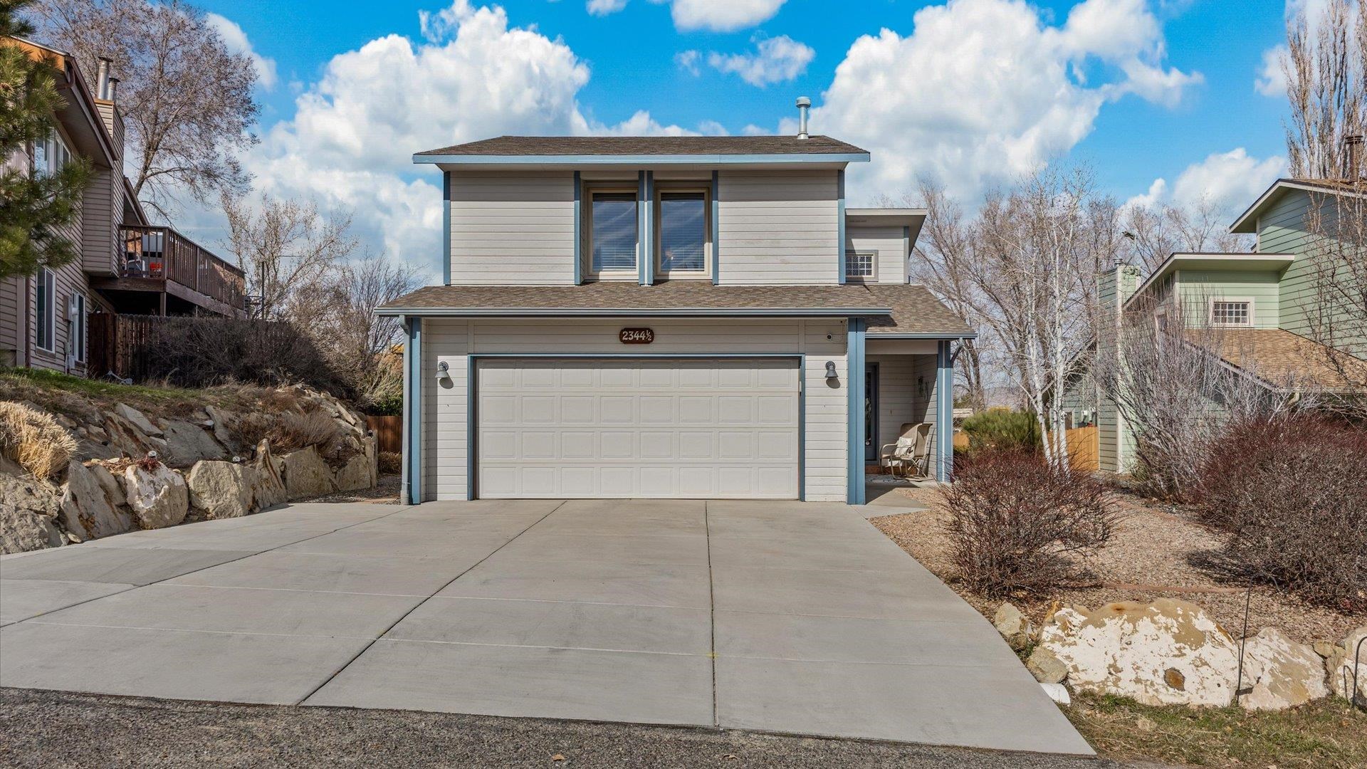 a front view of a house with a yard and garage