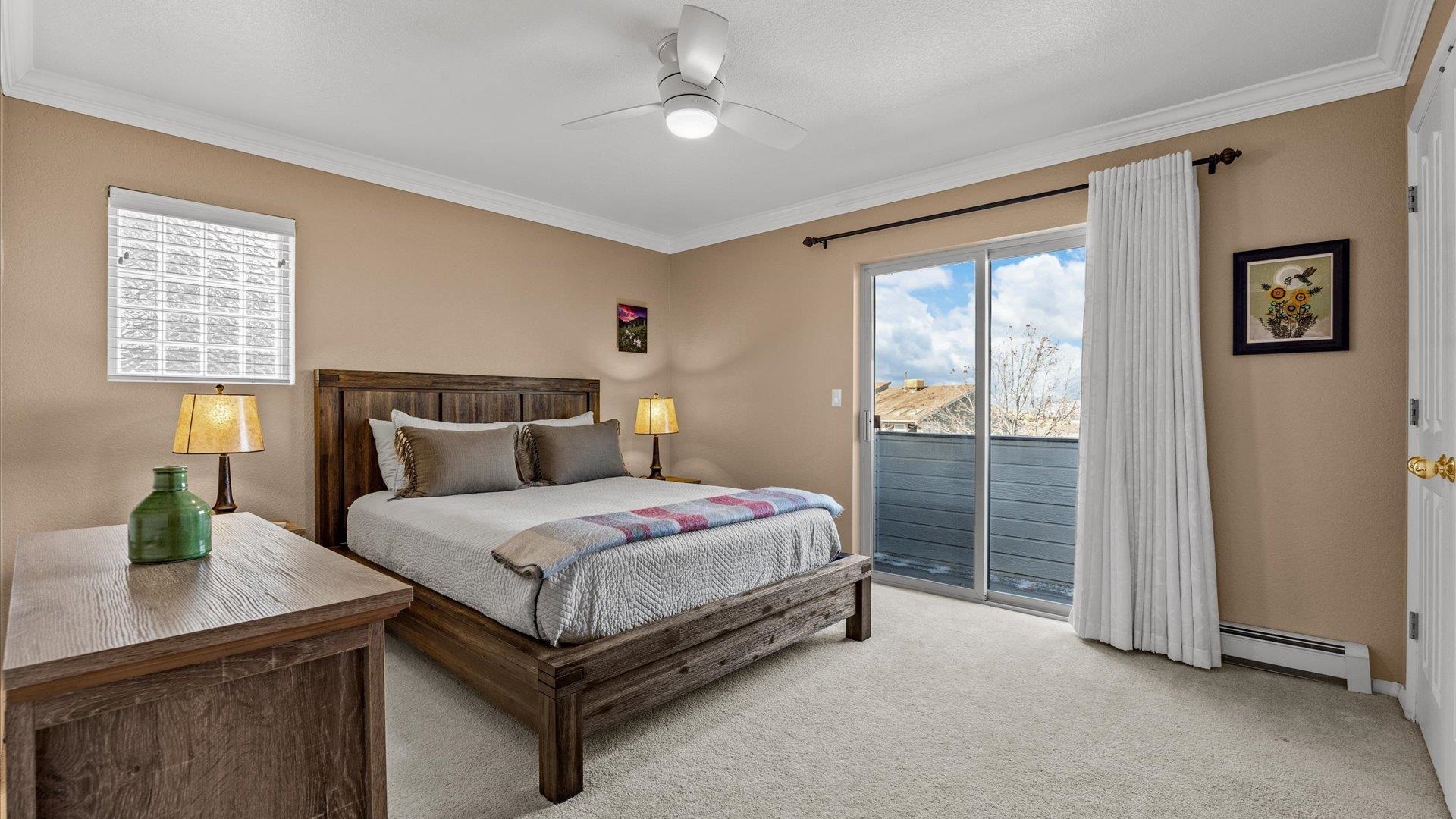 2344 1/2 Rattlesnake Court Grand Junction, CO 81507 - Photo 14 of 36 a bedroom with a large bed and a window