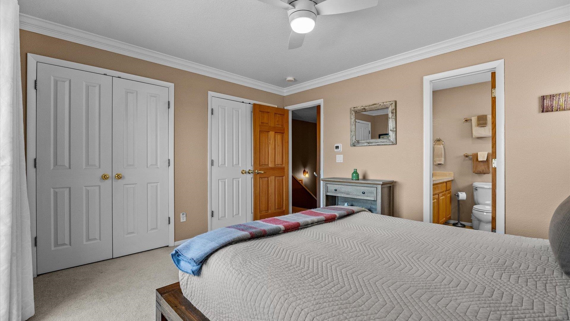 2344 1/2 Rattlesnake Court Grand Junction, CO 81507 - Photo 15 of 36 a bedroom with a large bed and chandelier