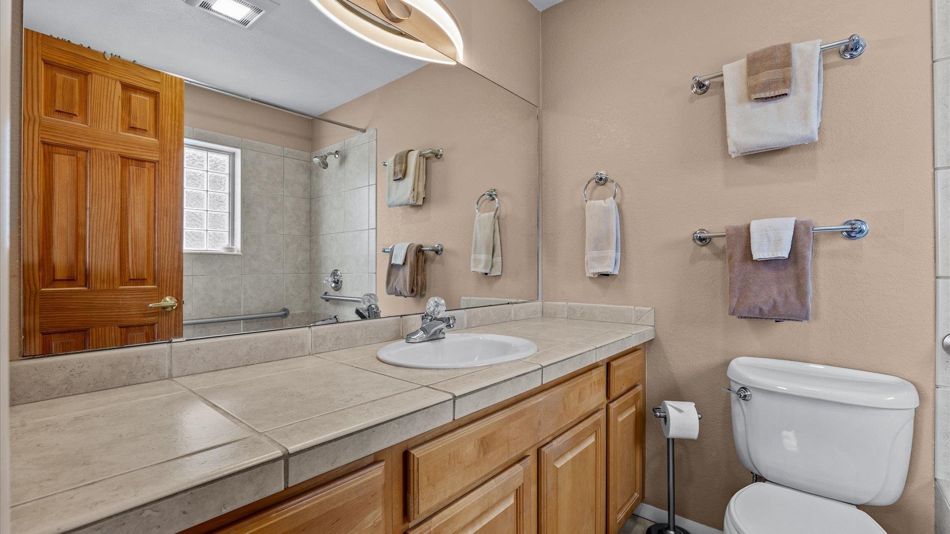 2344 1/2 Rattlesnake Court Grand Junction, CO 81507 - Photo 16 of 36 a bathroom with a granite countertop toilet sink and mirror