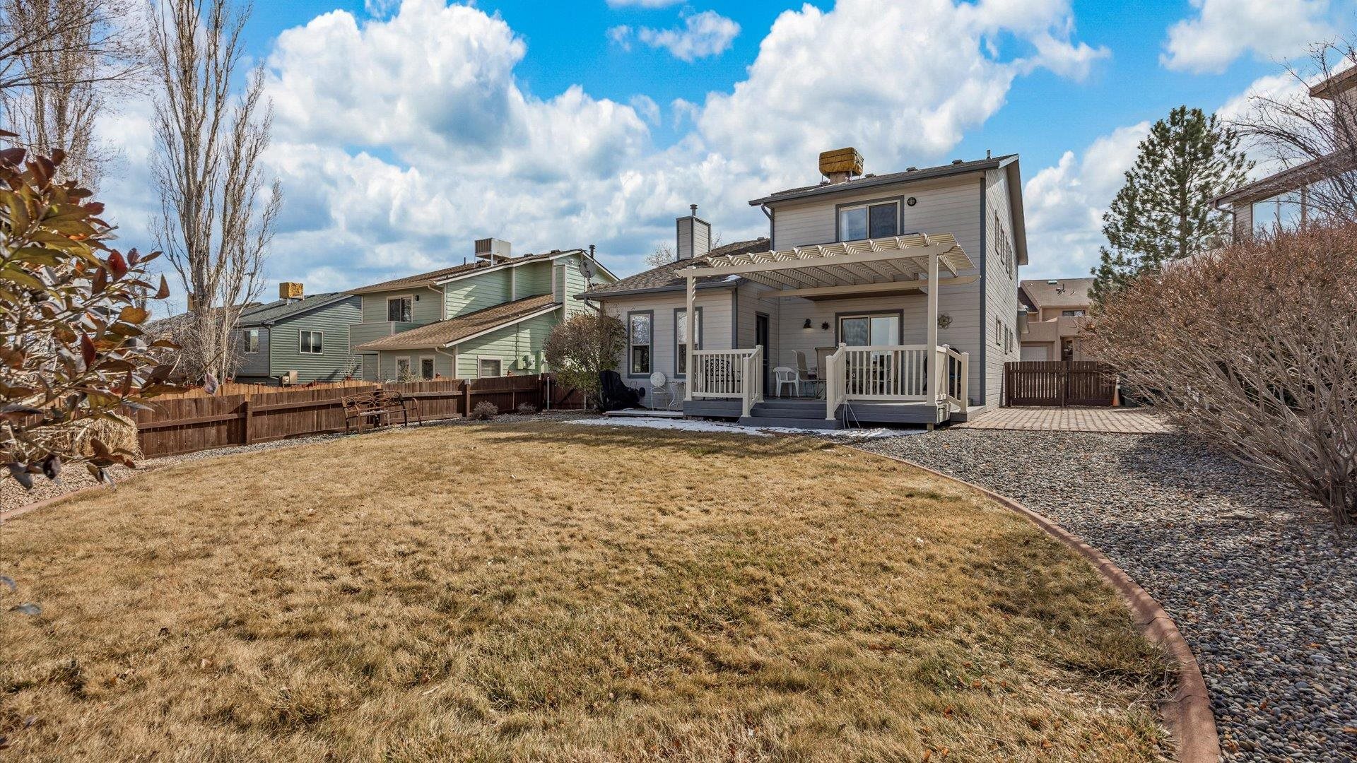 2344 1/2 Rattlesnake Court Grand Junction, CO 81507 - Photo 25 of 36 a front view of a house with a yard