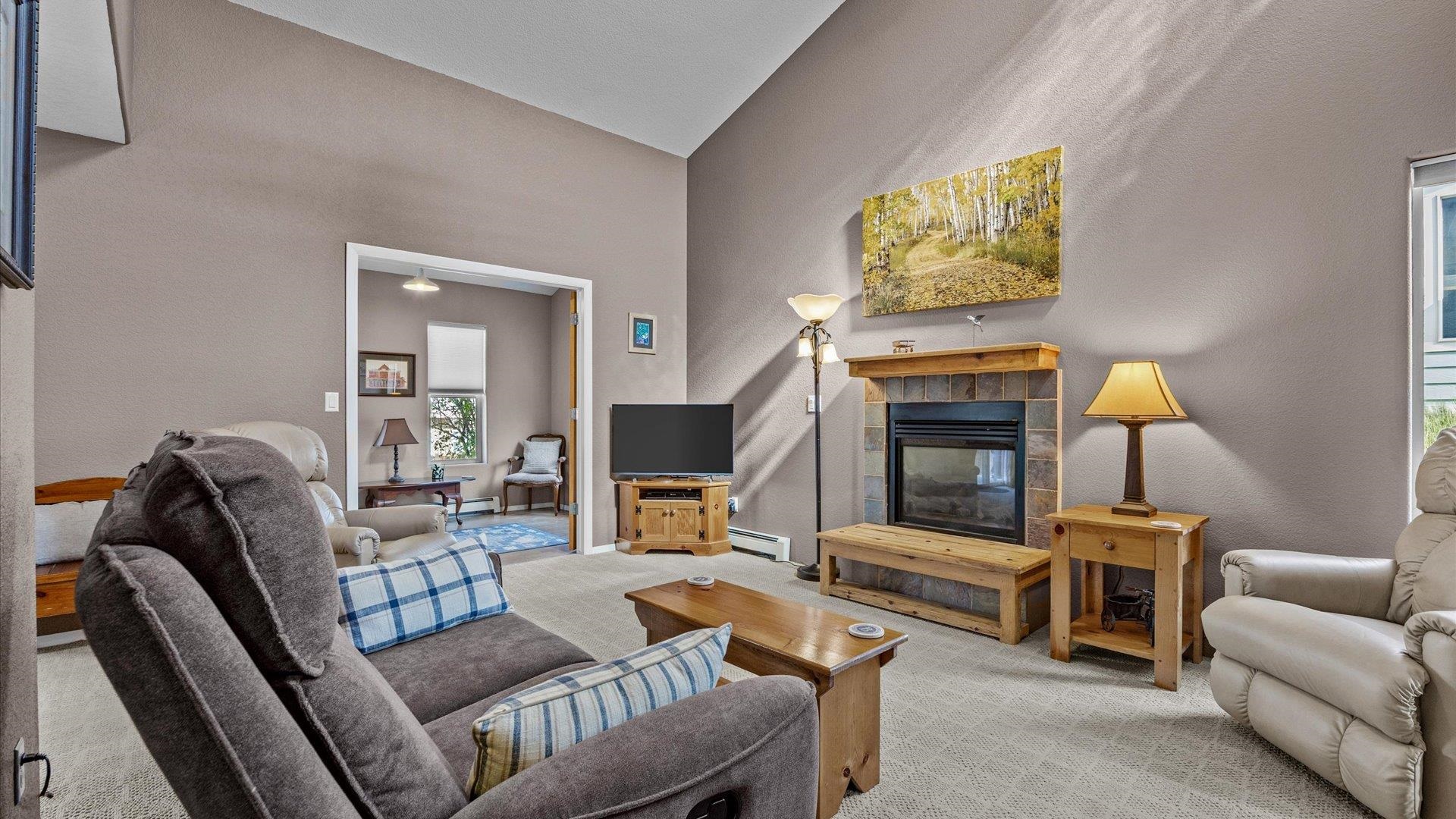 2344 1/2 Rattlesnake Court Grand Junction, CO 81507 - Photo 5 of 36 a living room with furniture and a fireplace