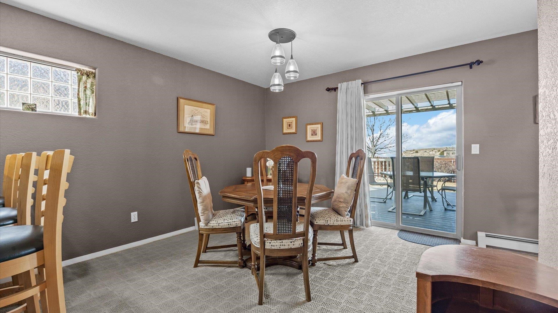 2344 1/2 Rattlesnake Court Grand Junction, CO 81507 - Photo 6 of 36 a view of a dining room with furniture and chandelier