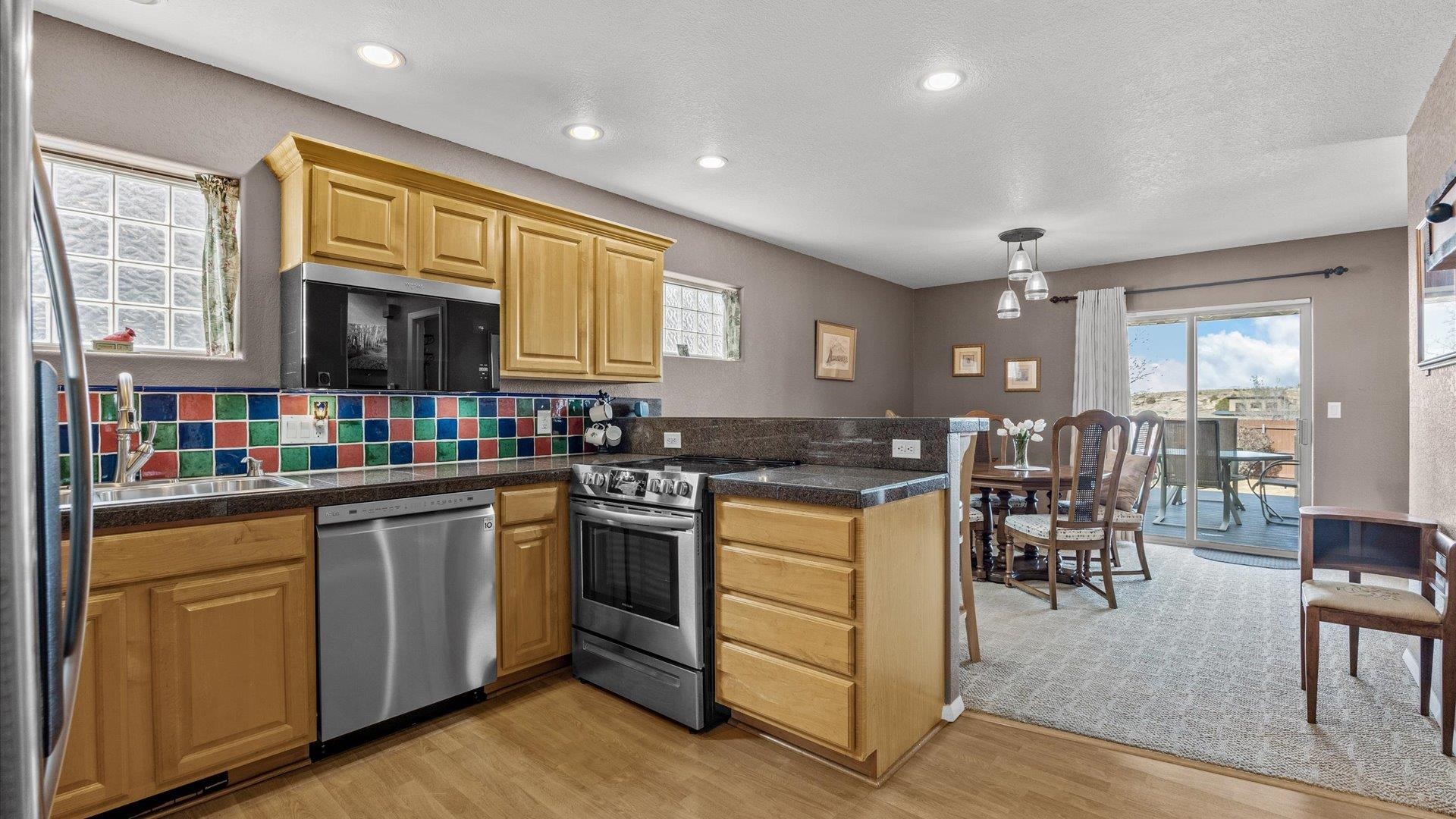 2344 1/2 Rattlesnake Court Grand Junction, CO 81507 - Photo 9 of 36 a kitchen with lots of counter top space and dining table