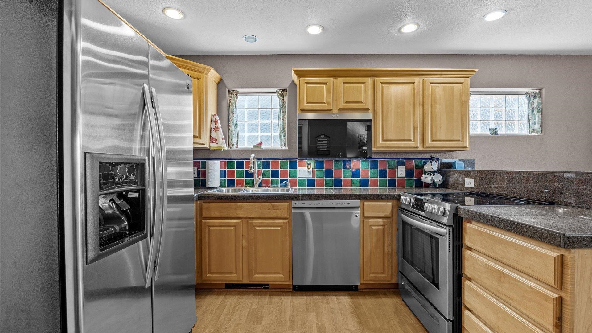 2344 1/2 Rattlesnake Court Grand Junction, CO 81507 - Photo 10 of 36 a kitchen with stainless steel appliances granite countertop a stove and a refrigerator