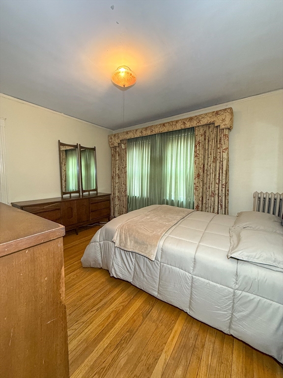 25 Clark Street Everett, MA 02149 - Photo 13 of 40 a bed sitting in a spacious bedroom next to a larger window