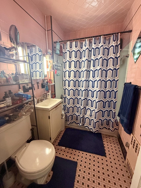 25 Clark Street Everett, MA 02149 - Photo 33 of 40 a bathroom with a sink toilet and shower