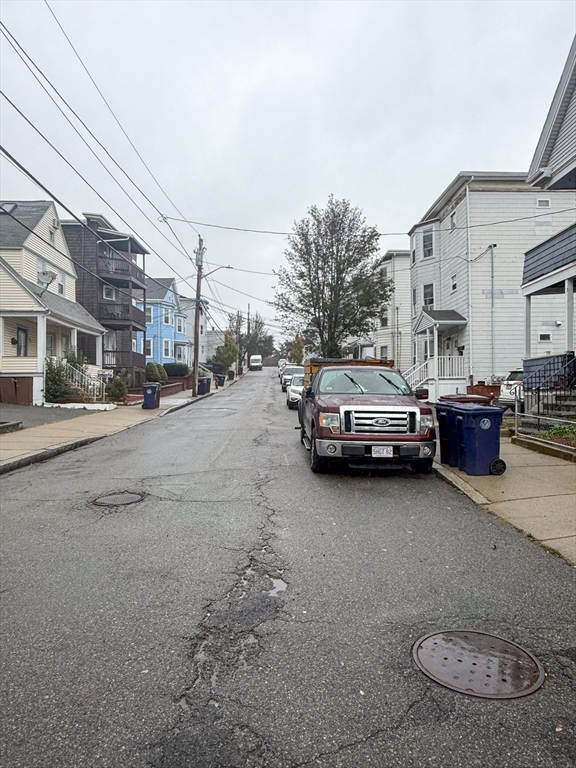 25 Clark Street Everett, MA 02149 - Photo 4 of 40 a view of a city street with a large car parked on the road