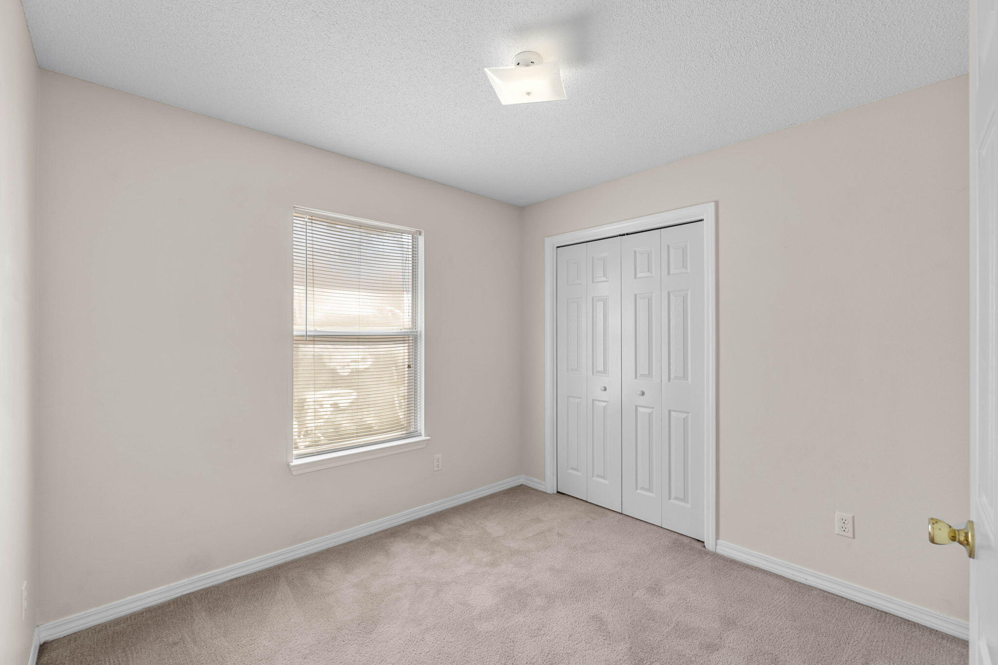 7612 Chablis Circle Navarre, FL 32566 - Photo 16 of 28 an empty room with windows and closet