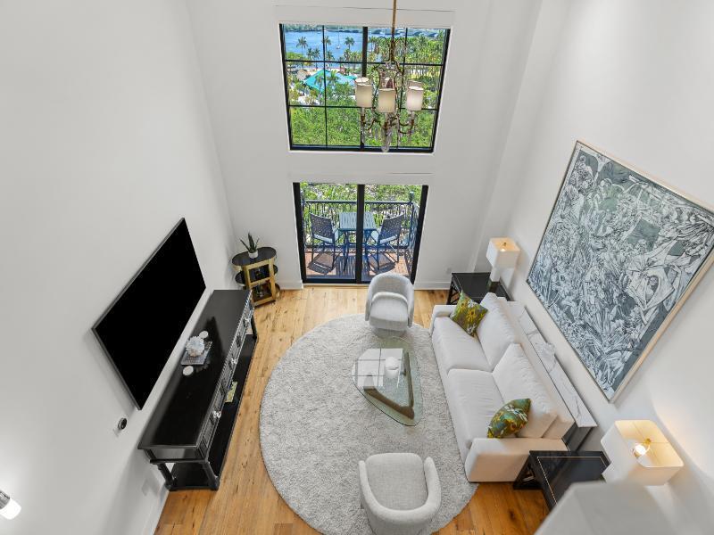 101 North Clematis Street, Unit 512 West Palm Beach, FL 33401 - Photo 11 of 17 a living room with furniture and a flat screen tv