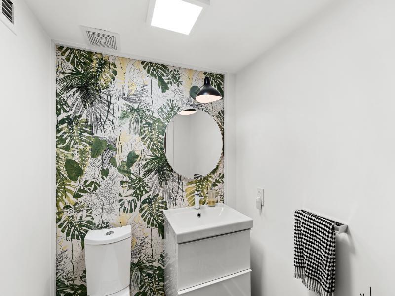 101 North Clematis Street, Unit 512 West Palm Beach, FL 33401 - Photo 12 of 17 a bathroom with a sink toilet and mirror