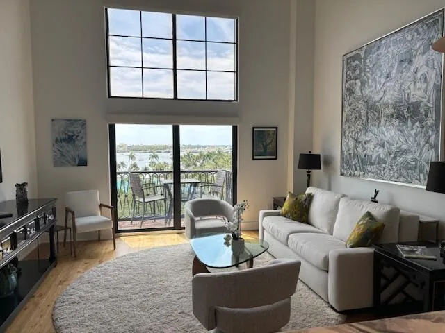 a living room with furniture and a floor to ceiling window