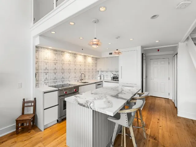 a kitchen with a sink stainless steel appliances and cabinets
