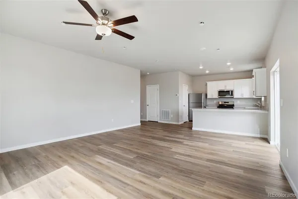 a large kitchen with stainless steel appliances granite countertop a stove a sink and a refrigerator