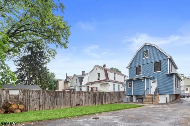 a front view of a house with a garden and plants