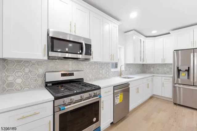 a spacious bathroom with a granite countertop sink a mirror and a shower