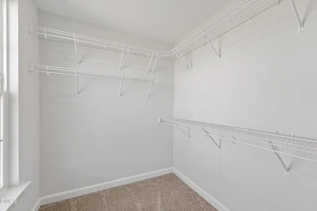 a bathroom with a sink a toilet a mirror and a window