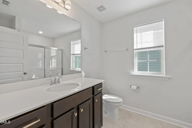 a bathroom with a sink double vanity and a mirror