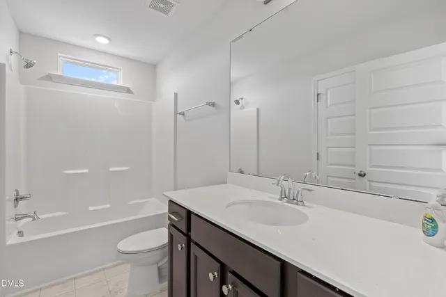 a view of a small space with wooden floor and a window