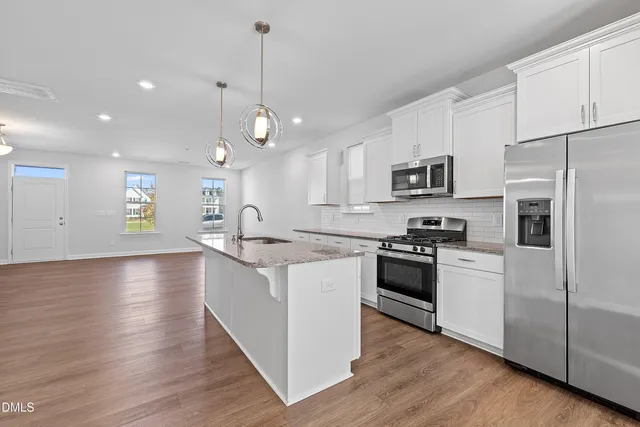 a view of room with window and wooden floor