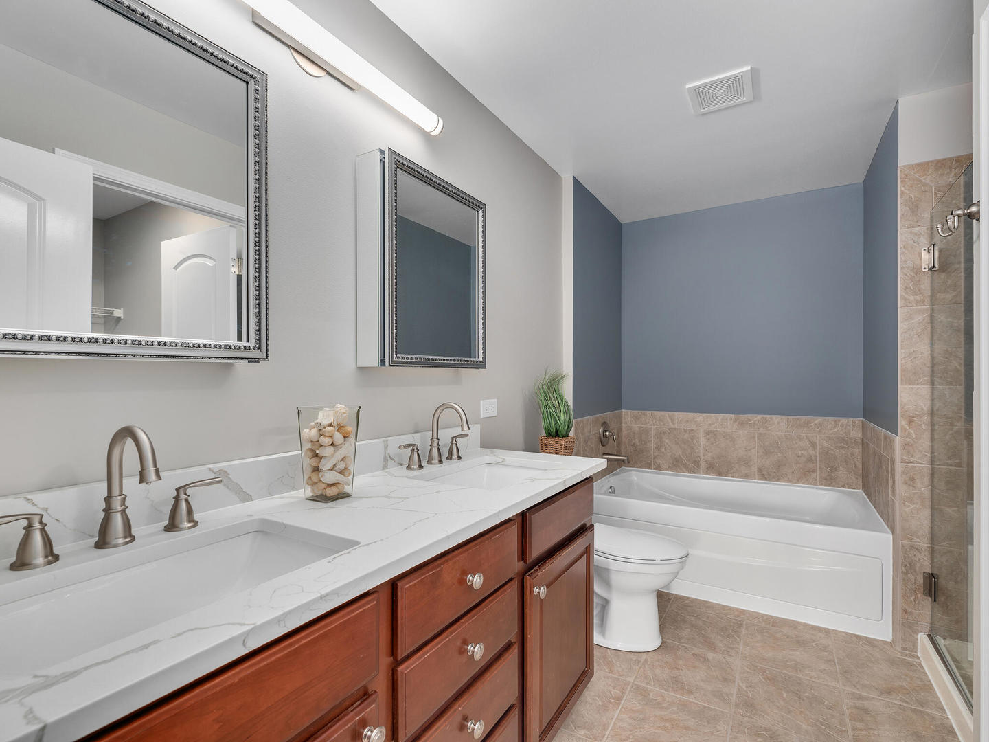 1117 Draper Road McHenry, IL 60050 - Photo 13 of 26 a bathroom with a double vanity sink and mirror with bathtub