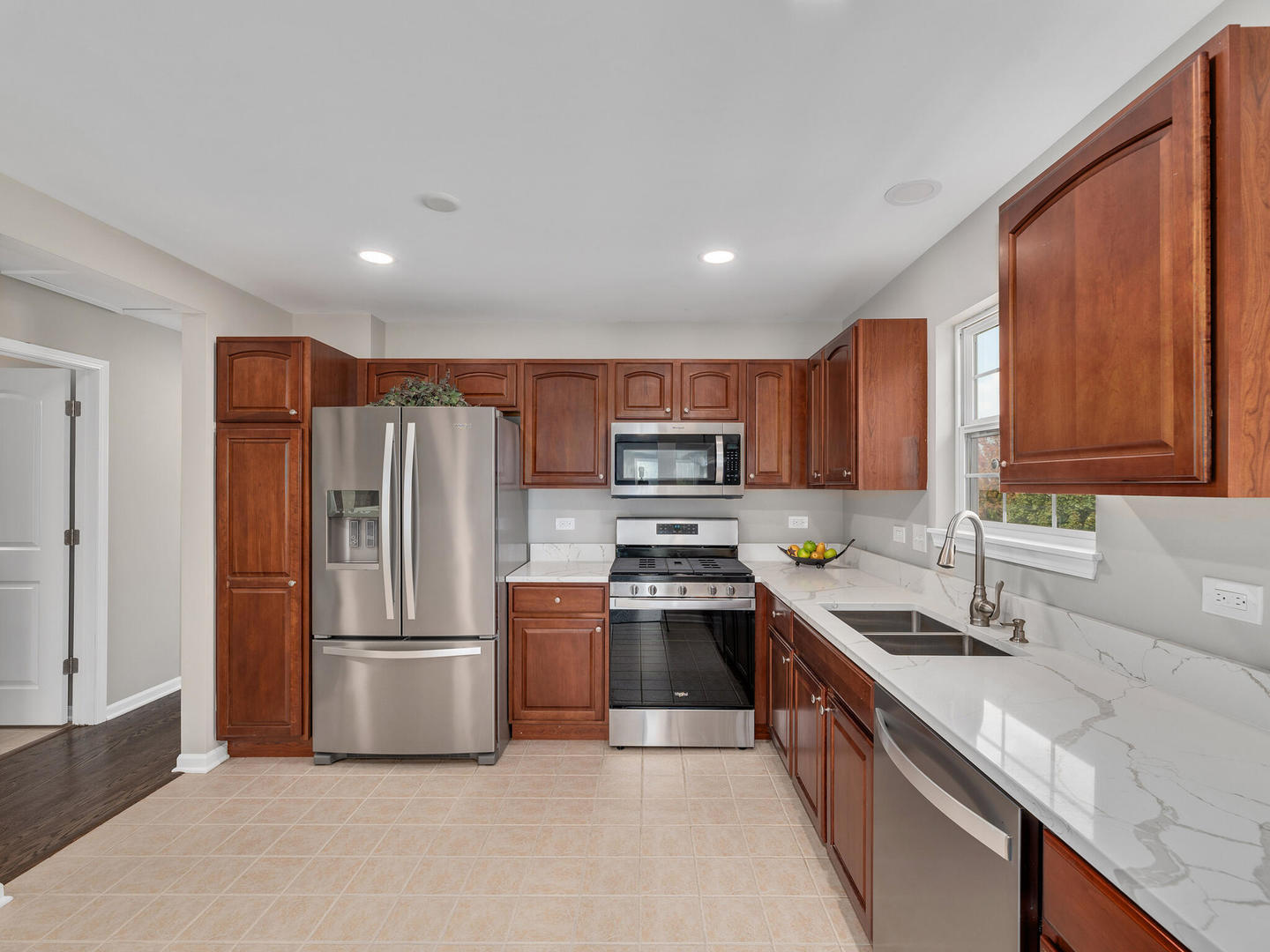 1117 Draper Road McHenry, IL 60050 - Photo 5 of 26 a kitchen with stainless steel appliances granite countertop a refrigerator stove and sink