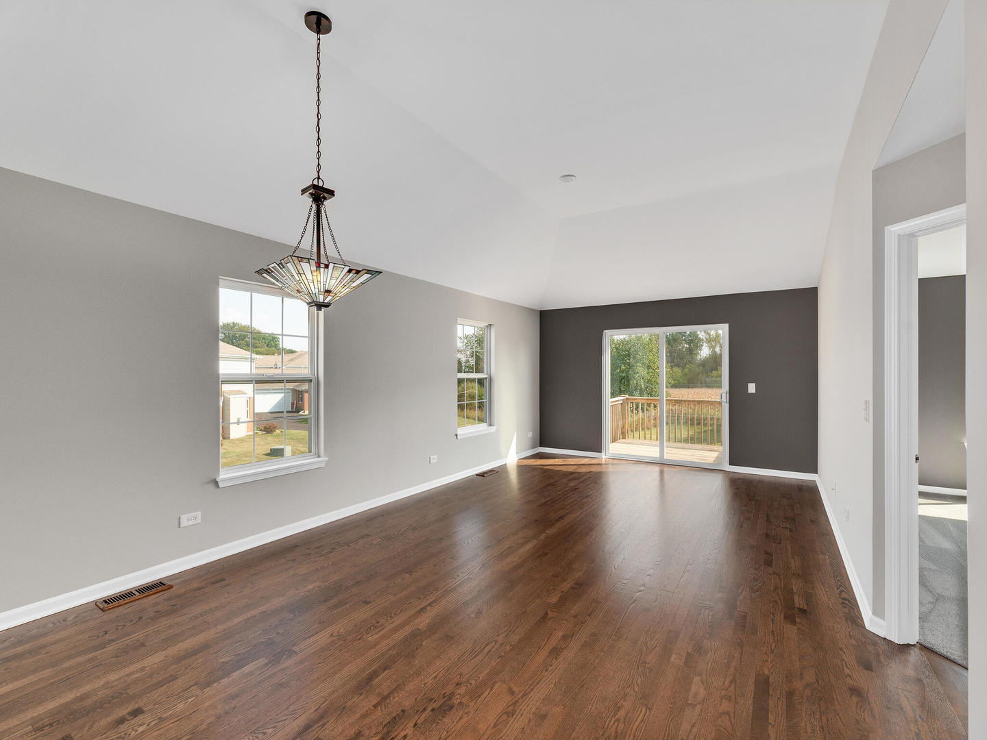 1117 Draper Road McHenry, IL 60050 - Photo 9 of 26 a view of an empty room with wooden floor and a window