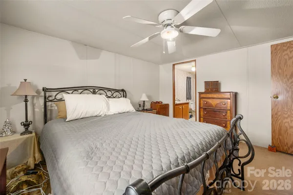 a bedroom with a bed and ceiling fan